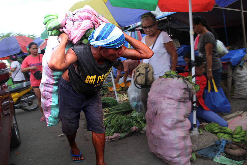  This porter receives 20 pesos for carrying 70 to 100 kilograms of vegetables and fruits in Bankerohan market. (Ace R. Morandante/davaotoday.com)