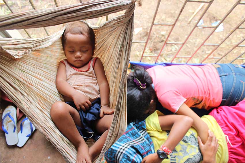 A child is sleeping tight in his makeshift hammock in the evacuation center in Barangay Balit, San Luis, Agusan  del Sur. (Contributed photo)