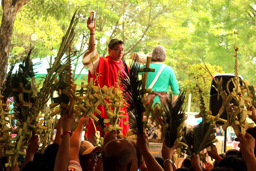 Catholic devotees attend the Sunday mass at St. Joseph The Worker parish in Sasa with their "lukay" made out of palm leaves, to start the observation of the Holy Week. (Medel V. Hernani/davaotoday.com)