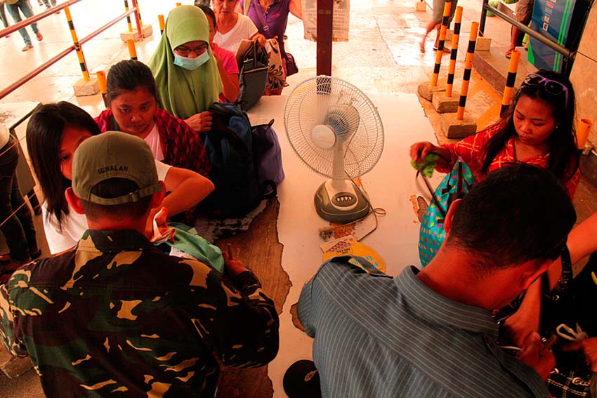 Combined forces of the Task Force Davao and Davao City Police Office inspect passenger's baggages at the Davao City Overland Transport Terminal on Holy Monday.  (Ace R. Morandante/davaotoday.com)