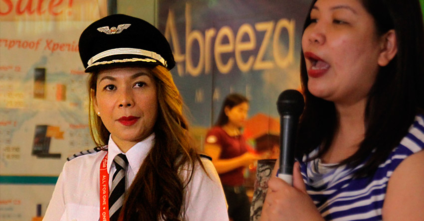 Capt Giselle Bendong (left) takes the control of Air Asia's Z2611 flight that cruises the Davao-Manila-Davao route. Beside her is Atty Joy Cañeba, Air Asia chief executive officer, who takes pride in the company's record of having women composing 40 percent of the crew. The recent Davao-Manila-Davao flight has the first all-female crew in the history of Philippine Air Asia. (Ace R. MOrandante/davaotoday.com)