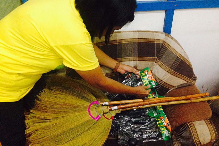 A teacher from Kapitan Tomas Monteverde Sr Central Elementary School arranges the donations given by a mall in Davao City on Wednesday afternoon. (Zea Io Ming C. Capistrano/davaotoday.com)