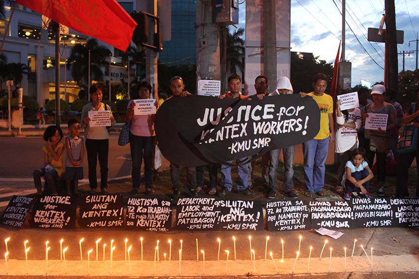 Five days after the fire razed Kentex Manufacturing Inc., militant groups in Davao City held a candle-lighting activity and offered prayers for the 72 workers who died during the incident. (Medel V. Hernani/davaotoday.com)