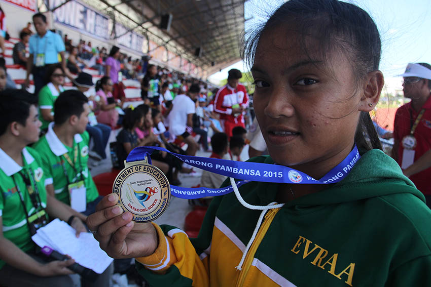 Rose Marie Olovida from Eastern Visayas gets a gold medal on the long jump secondary girls event during the 2015 Palarong Pambansa in Tagum City, Davao del Norte. (Ace R. Morandante/davaotoday.com)