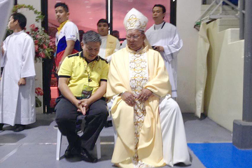 Education Secretary Bro. Armin Luistro, FSC chats with Tagum Bishop Wilfredo D. Manlapaz inside the RDR Gymnasium for the Thanksgiving Mass during the conduct of 2015 Palarong Pambansa at Tagum City, Davao del Norte. (Mart Sambalud/davaotoday.com)