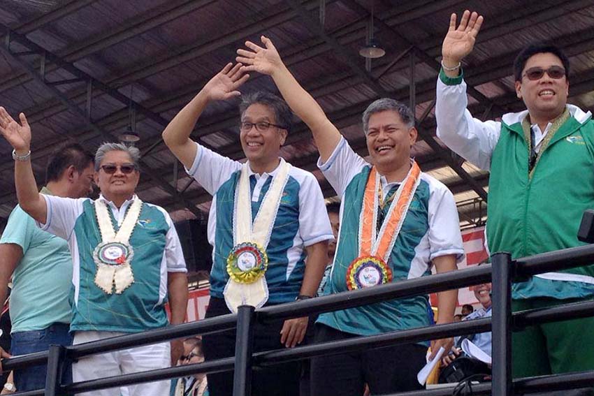 Interior Secretary Mar Roxas waves to the crowd during the opening of the 2015 Palarong Pambansa in Tagum City, Davao del Norte on Monday. He was joined by (L-R) Governor Rodolfo Del Rosario, Education Secretary Bro. Armin Luistro, FSC and Davao del Norte 1st District Representative Anthony del Rosario. (Mart D. Sambalud/davaotoday.com)