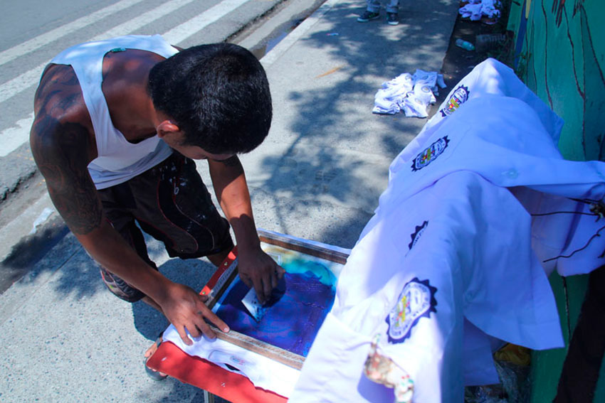 T-shirt printing is a booming business during school opening. Logo printing is offered at P20 for a small logo print and P50 for a larger logo outside Kapitan Tomas Monteverde Senior Central Elementary School during the first day of enrollment. (Ace R. Morandante/davaotoday.com)