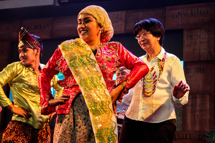 Board of Trustee member Ms. June Rodriguez dances onstage with performers from the Kaliwat Performing Arts Collective to entertain the crowd in celebration of Foundation for a Sustainable Society's (FSSI) 20th anniversary, held in NCCC Mall, Davao City on Wednesday. FSSI is a non government organization (NGO) that "provides development and financing assistance to social enterprises in the country's poorest and marginalized sectors." (Paulo C. Rizal/davaotoday.com)