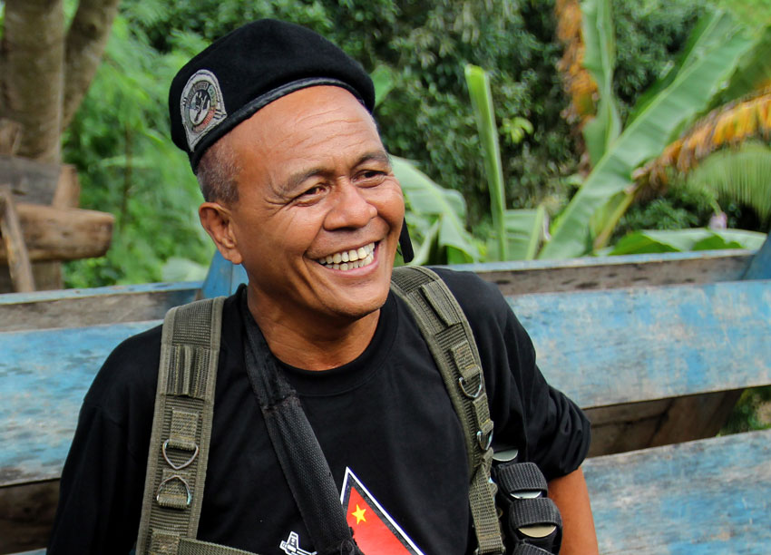 Leoncio Pitao alias Ka Parago flashes a smile to the members of the press during the release of five prisoners-of-war on July 31, 2013 in Paquibato District, Davao City. The five POWs belonged to the 60th Infantry Battalion of the Army and were held captive by the New People's Army for 44 days. (Ace R. Morandante/davaotoday.com)