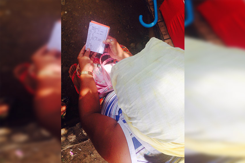 Rosalie Gana holds the list of requirements she needs to buy for her daughter who is in Grade 7 in Tugbok National High School. Among the requirements, she crossed out school supplies which she said she could not buy because they are too expensive including pastel crayons, colored pencils and scissors. (Zea Io Ming C. Capistrano/davaotoday.com)