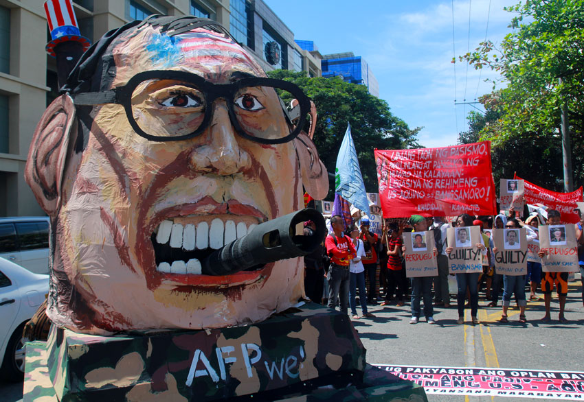 An effigy of President Benigno Aquino III on board a military tank is brought by activists from various organizations to portray what they call as a "militaristic government" during their version of State of the Nation Address in Davao City on Monday. (Ace R. Morandante/davaotoday.com)