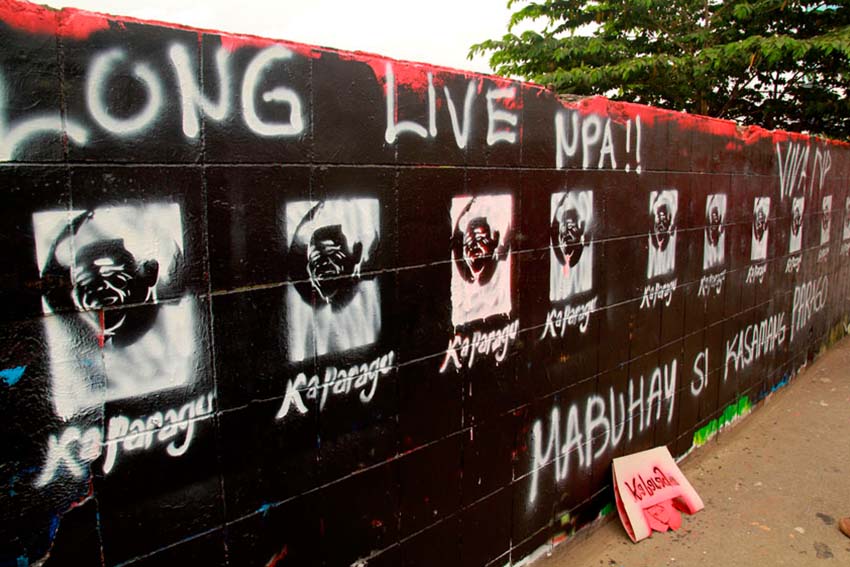 REPAINT. Members of the underground youth movement repaint the graffiti wall along Matina highway in Davao City with images of Kumander Parago and the words Long Live the New People's Army. On Thursday afternoon local artist finished a mural of Kumander Parago, however it was defaced in black paint immediately.(Ace R. Morandante/davaotoday.com)