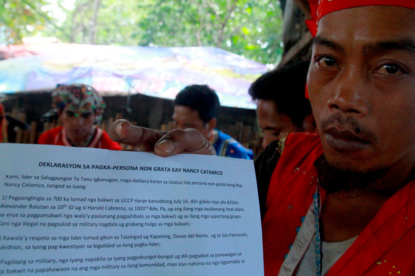 A member of the tribal group Salugpungan Ta Tanu Igkanugon shows their statement calling North Cotabato 2nd District Representative Nancy Catamco as persona non grata. (Ace R. Morandante/davaotoday.com)