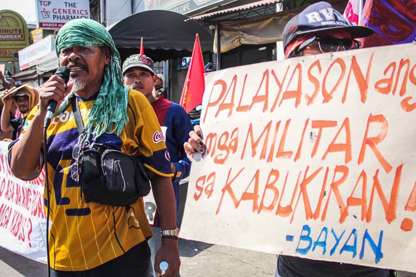 Bello Tindasan, chairman of Compostela Farmers Association (CFA), along with other farmers, protests in front of the Army's Eastern Mindanao Command Headquarters in Davao City a week before President Aquino's last State of the Nation Address (SONA) to condemn alleged human rights violations against peasants and activists. Tindasan's house in Compostela Valley was strafed by alleged by Army men last June. (Paulo C. Rizal/davaotoday.com)