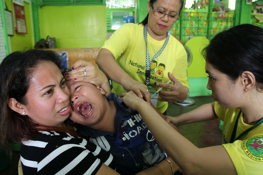 A grade 1 pupil of Kapitan Tomas Monteverde Senior Central Elementary School cries while he gets a vaccination from the personnel of the City Health Office on Wednesday morning as part of the Department of Health campaign for the National Immunization Month. (Ace R. Morandante/davaotoday.com)