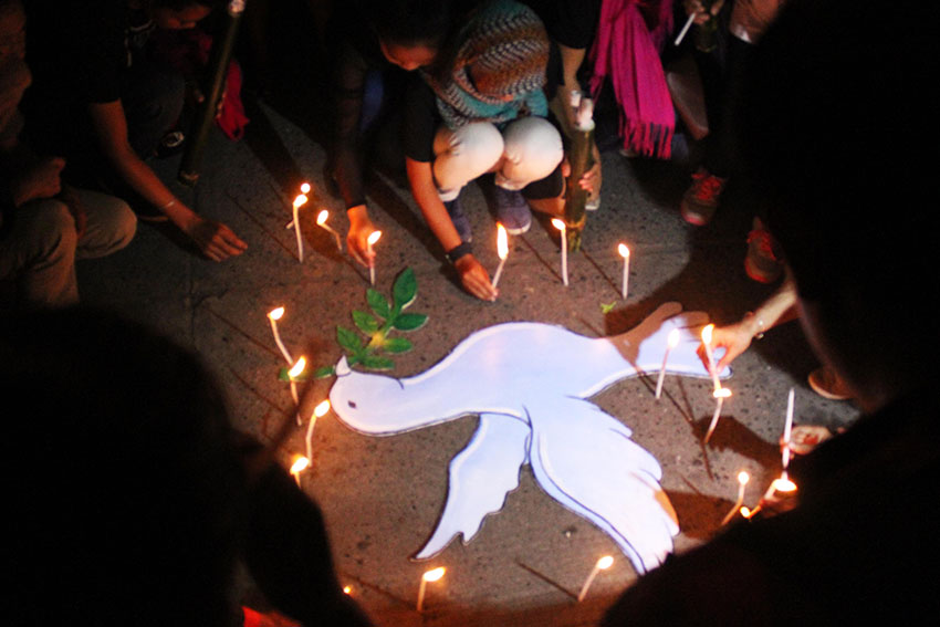 Youth convenors of Rise for Education alliance light candles along Freedom Park in Davao City before they lead hundreds of delegates of the International Solidarity Mission 2015 in a torch march going to United Church of Christ in the Philippines Haran compound where the Lumad evacuees are staying.