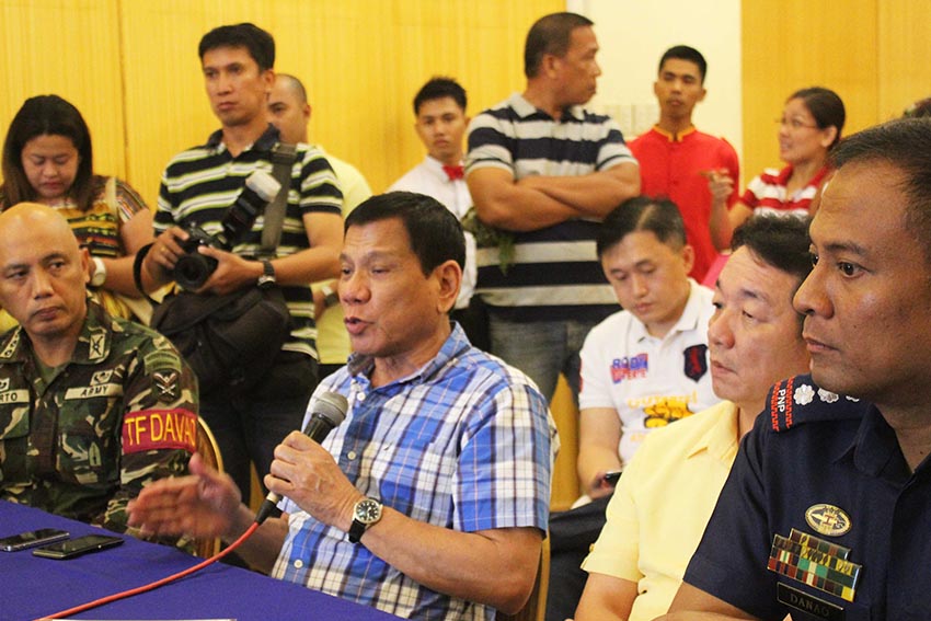 Davao City Mayor Rodrigo Duterte discusses during command conference held Wednesday at Menseng Hotel the security plan for the Kadayawan Festival with  Davao City Police Office Chief Sr. Supt. Vicente Danao Jr. (right) and TF Davao Chief Col. Macairog Alberto (left).