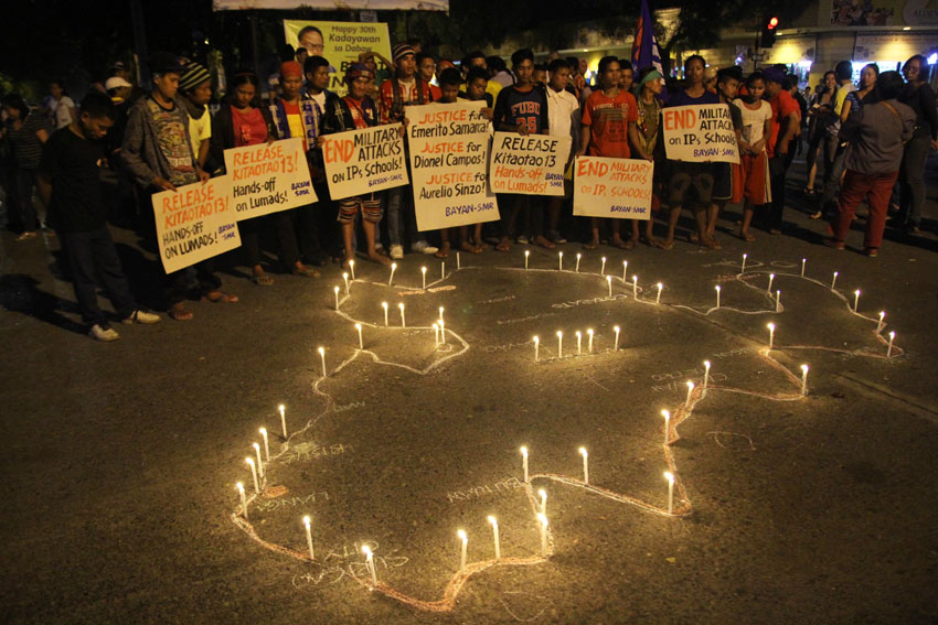 Militant organizations draw a map of Mindanao and lit candles around it to condemn the recent killings in Surigao del Sur and Bukidnon allegedly by militia groups. (Ace R. Morandante/davaotoday.com)