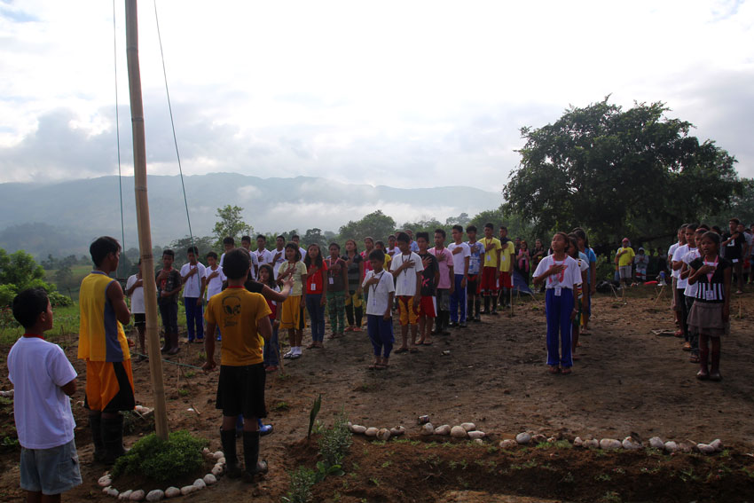 Grade 7 and 8 pupils of Misfi Academy in Sitio Dao, Barangay White Culaman, Kitaotao, Bukidnon sing the national anthem before going to their classes at 7:00 in the morning Thursday. Their school is now threatened to be "closed or burned" by Barangay Captain Felipe Cabugnason because he said the school is built by the New People's Army. (Ace R. Morandante/davaotoday.com)