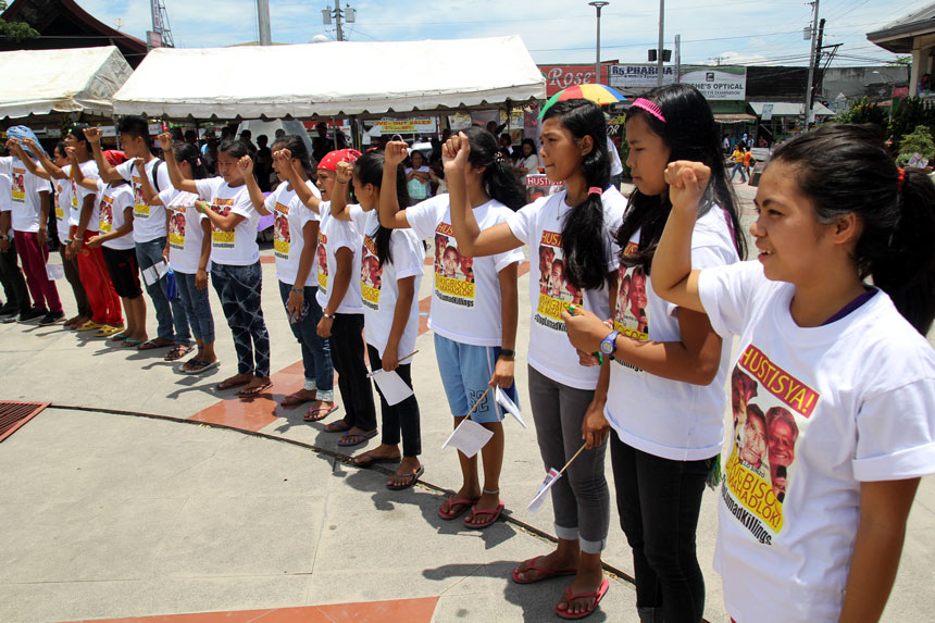 Alcadev students raise their fists to salute their school director, "Sir Emok" and vowed to continue what he has started for the education of the Lumads in Surigao del Sur. 