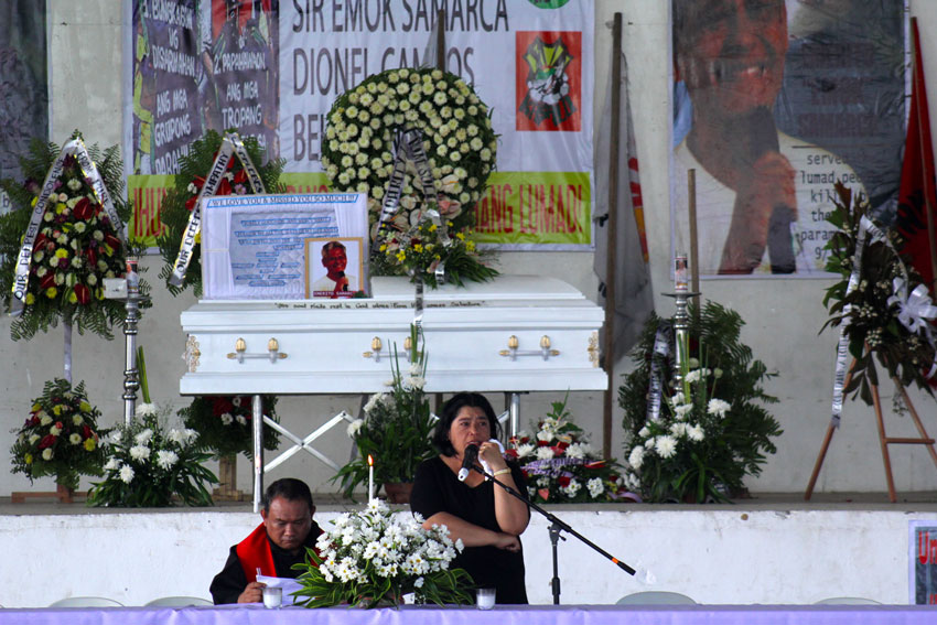 Yosie Samarca, wife of the slain Executive Director of Alcadev Emerito "Emok" Samarca, is overwhelmed by the crowd who attended the mass at the capitol gym of Butuan  City.