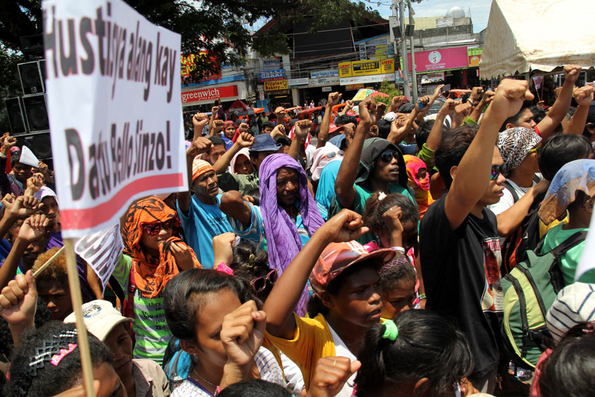 People raise their fists for Emerito Samarca as the sign to continue the struggle what was left by there Sir Emok.