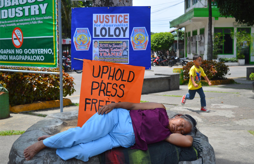 An old and frail woman is comfortably sleeping under the shade of a tree in front of the old Tagum City Hall, while Davao del Norte media hold their rally for  Gregorio Ybañez, a journalist, who was slain by unidentified assailants last month. (Mart D. Sambalud/davaotoday.com)