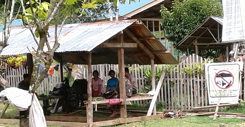 ARMY IN SCHOOL? Members of the 36th Infantry Battalion are seen inside the shed owned by the Alternative Learning Center for Agriculture and Livelihood Development (Alcadev) outside the school entrance. Karapatan Caraga said this picture was taken on Monday at around 9:30 am. The waiting shed is right across the MAPASU cooperative that was burned down by armed men later that afternoon. (Photo contributed by Karapatan Caraga)