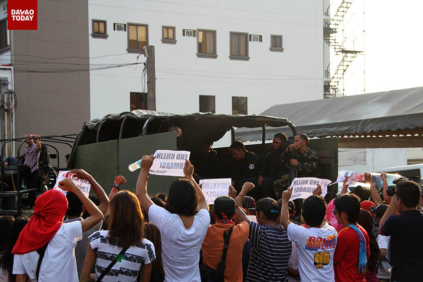 A group of activists gets close to an Army truck full of soldiers while shouting "berdugo (butchers)" after a visit of President Benigno Aquino III in Davao City. The group held a protest several meters away from a school where Aquino visited to demand justice for the killings of Lumads in Mindanao. (John Rizle L. Saligumba/davaotoday.com)