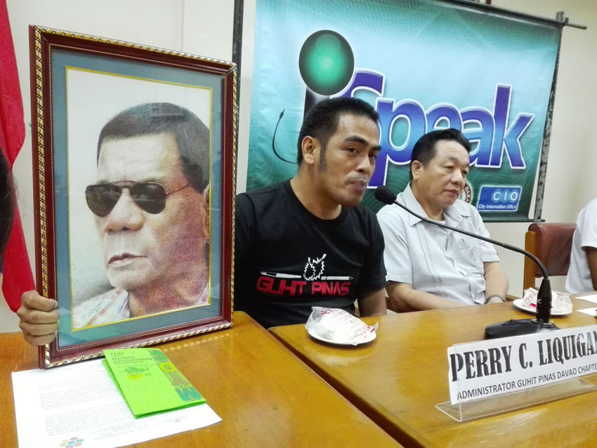 ARTIST Perry Liquigan shows the "pen-in-ink" portrait of Davao City Mayor Rodrigo Duterte. Part of the proceeds of the sale of this P15,000-portrait, and of the other portraits of 20 artists now in exhibit at Museo Dabawenyo will be for the benefit of a Badjao tribal coastal community in Matina Aplaya, Davao City.(John Rizle L. Saligumba/davaotoday.com)