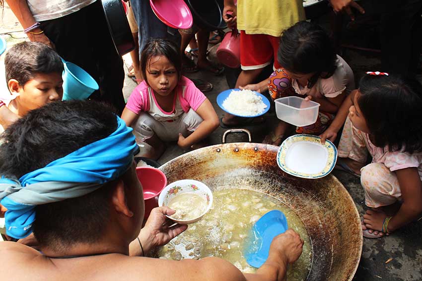 At 11:30 am, Lumad children get their share of food at the kitchen inside the evacuation camp in the United Church of Christ in the Philippines Haran compund.(Medel V. Hernani/davaotoday.com)