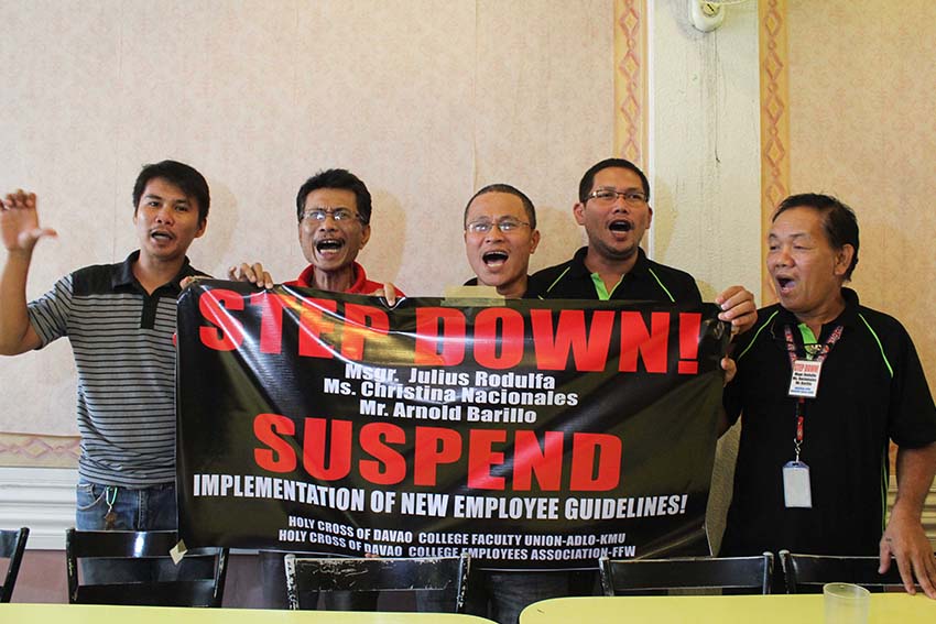 (From left) Socrates Luayon of the Holy Cross of Davao College Faculty Union (HCDCFU-ADLO-KMU) and Marlon Mendoza of the Holy Cross of Davao College Employees Association (HCDCEA-FFW) call to suspend the implementation of new employees guidelines, which school President Msgr. Julius Rodulfa, Vice President for administration Christina Nacionales and  Human Resource Manager Arnold Barillo approved. The leaders said the guidelines were revised without their consent which violates the collective bargaining agreement between their unions. They are also calling for the stepping down of the said school administrators. (Medel V. Hernani/davaotoday.com)