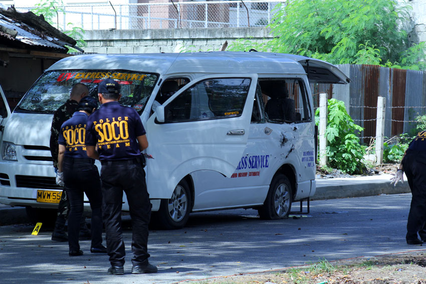 An operative of SOCO (Scene of the Crime) checks the UV Express Services passenger van from Pikit, North Cotabato after an improvised explosive device exploded in Ecoland, Davao City Wednesday morning.(Ace R. Morandante/davaotoday.com)