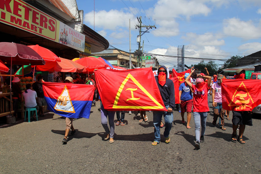 Members of the youth underground movement Kabataang Makabayan in Davao City commemorate their 51st founding anniversary with a lightning rally in along Bankerohan Public Market on Monday morning. (Ace R. Morandante/davaotoday.com)