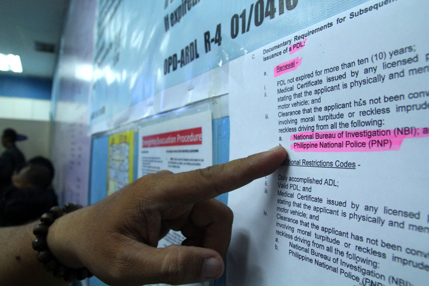 An applicant for a driver's license checks out the latest implementation of the Land Transportation Office in Regional XI of their new requirements for renewal which include clearance from the National Bureau of Investigation and the Philippine National Police. (Ace R. Morandante/davaotoday.com)