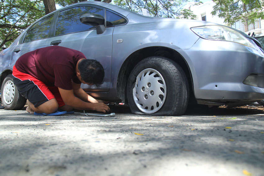  DAMAGED. A car-owner checks his car which was parked along Ecoland Drive where a passenger van exploded. (Ace R. Morandante/davaotoday.com)