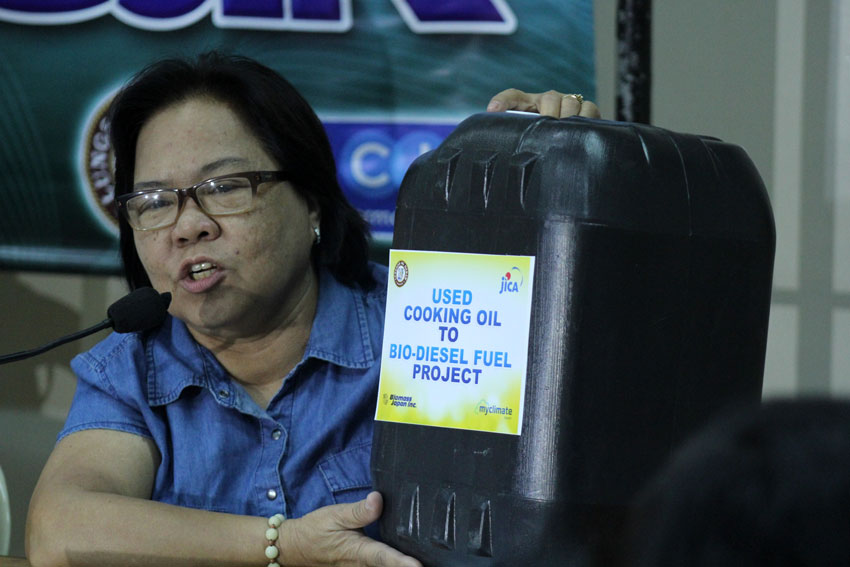 Eliza Madrazo, chief of City Environment and Natural Resources Office shows the sample of the container which will be distributed in 13 barangays to collect used oil. The container was donated by MyClimate Japan. (Ace R. Morandante/davaotoday.com)