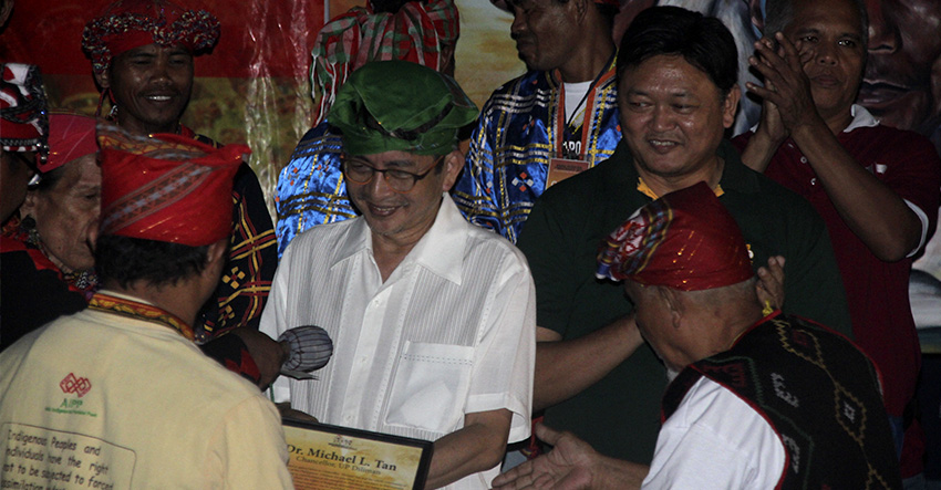 TUBAW. University of the Philippines Diliman Chancellor Michael Tan (in green tubaw) accepts the tokens of appreciation from the lumads of Manilakabayan 2015 during the 'Gabi ng Pasasalamat' prepared by the lumads at the College of Human Kinetics on Friday evening. (Earl O. Condeza/davaotoday.com)