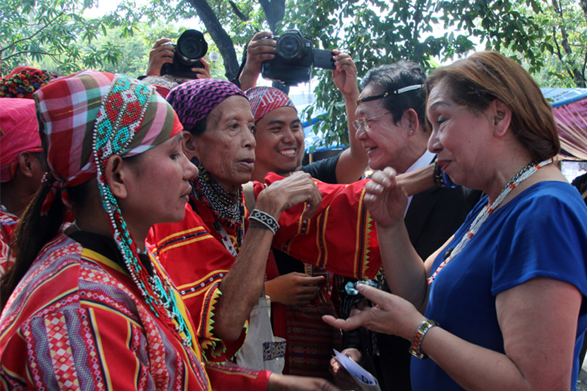 A Matigsalog leader from Talaingod, Davao del Norte, Bai Bibyaon Bigkay, gives a necklace to Atty. Rosario Setias-Reyes (in white), president of the Integrated Bar of the Philippines, to show her tribe's gratitude on the assurance of the lawyers group to help the Lumads on their call to stop the killings of their leaders and tribal members. (Earl O. Condeza/davaotoday.com)