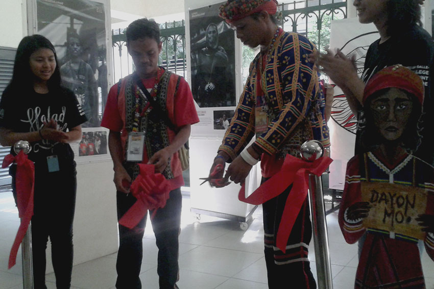 The De La Salle - College of St. Benilde starts its week-long photo exhibit dubbed as 'Halad sa Lumad' (Offer to Lumads) to depict the plight of Lumads in Mindanao. Datu Bogok, together with De La Salle students led the ribbon cutting. (contributed photo)