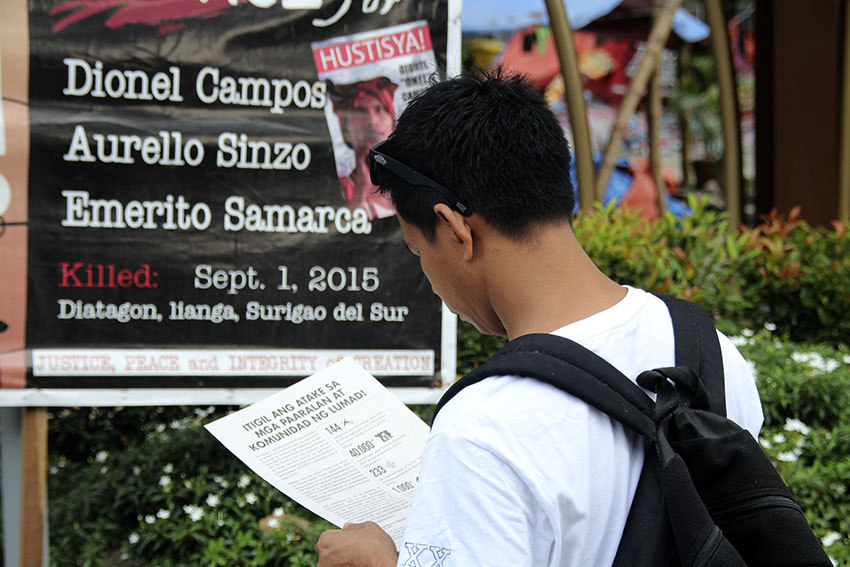 A churchgoer in Baclaran Church takes time to read the leaflet distributed by volunteers of Manilakbayan 2015 which discusses the issues of the Lumads in Mindanao. (Earl O. Condeza/davaotoday.com)