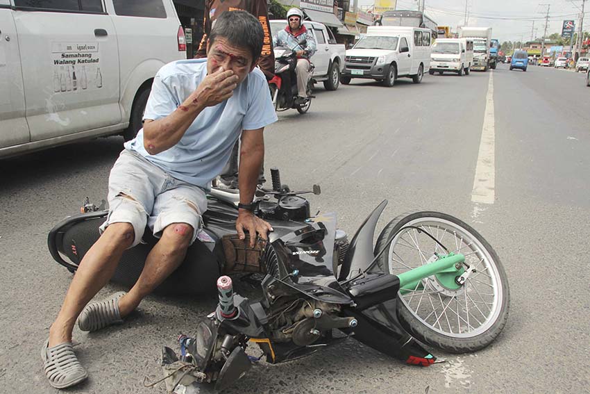 This motorcycle driver sustains cuts on different parts of his body after hitting a young boy who crosses the street along Panacan highway in Davao City on Thursday afternoon.  (Medel V. Hernani/davaotoday.com)