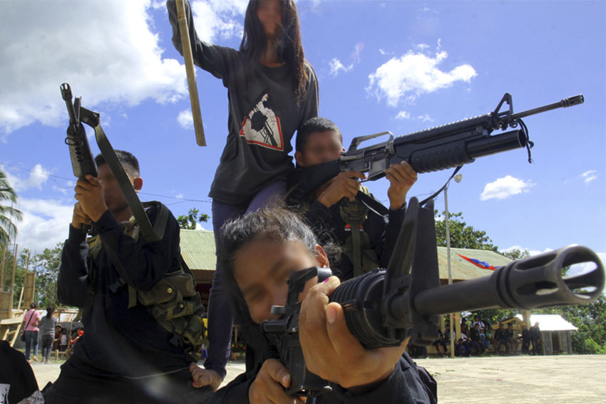 Members of the New People's Army strike a dramatic tableau for their martyr-comrades in a cultural presentation somewhere in Bukidnon. (Ace R. Morandante/davaotoday.com)