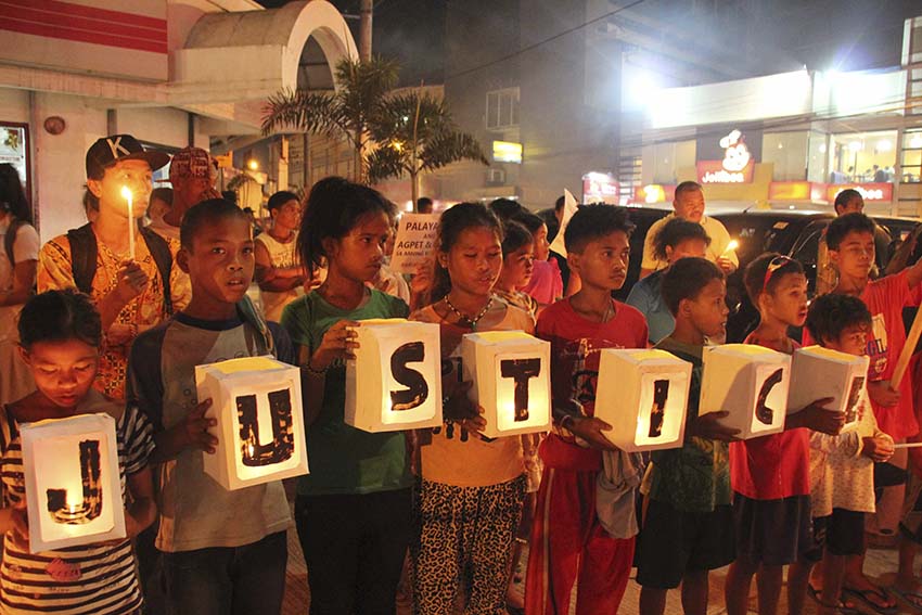 133 Matigsalog residents  from Purok 4, Barangay Mangayon, Compostela Valley Province, seek refuge in Davao City after they were dislocated due to militarization. On the 3rd year commemoration of Typhoon Pablo, the Lumads light candles along Matina Crossing. (Medel V. Hernani/davaotoday.com) 