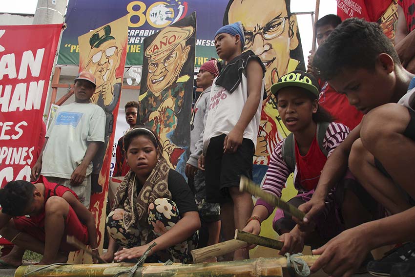 These tribal students use bamboo during a noise barrage in front of the Armed Force's Eastern Mindanao Command headquarters in Panacan, Davao City during the commemoration of the 67th International Human Rights Day. The Lumads call for the disbandment of paramilitary troops which they alleged as organized by the military. (Medel V. Hernani/davaotoday.com)
