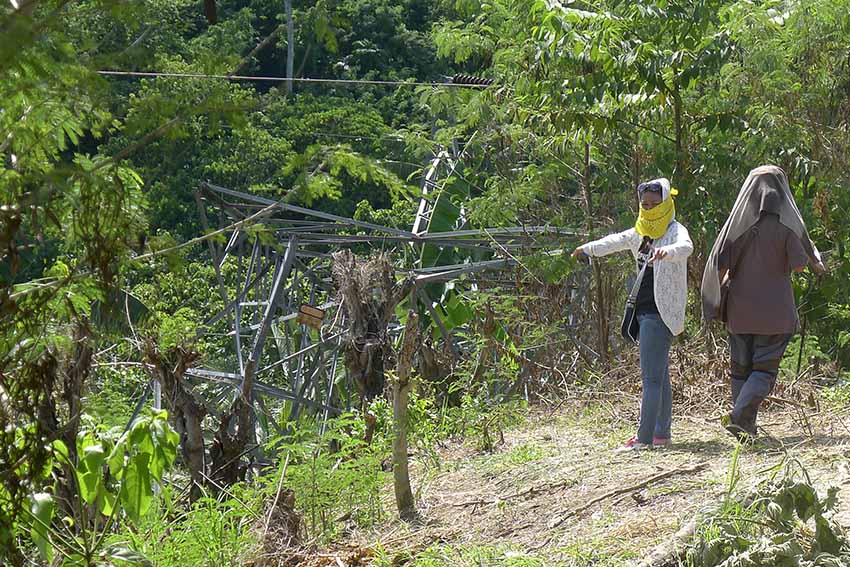 A power line tower of the National Grid Corporation lies across a corn field after being taken down by a bomb attack at 9:26 pm Thursday in Sitio 1, Barangay Pagangan, Aleosan, Cotabato Province. The bombing sent North Cotabato, Cotabato City and Maguindanao in darkness.(Photo by Mariline Cantomayor)