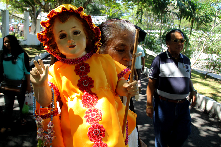 BACK TO WORK. After her Santo Niño is blessed, this old woman goes back to her booth outside the Shrine of the Holy Infant of Jesus of Prague to sell foods to people who also go to the Shrine hills in Matina, Davao City.  (Ace R. Morandante/davaotoday.com)