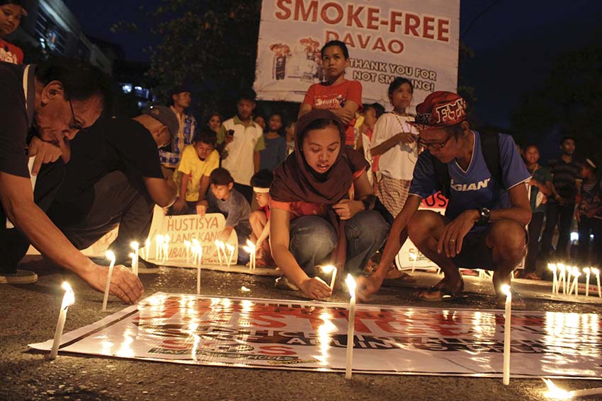 Activists and indigenous peoples advocates hold a candle lighting activity at the Freedom Park in Davao City on Monday to call for justice for a Manobo student who was killed on Sunday by a suspected member of the paramilitary group Alamara in Sitio Laslasakan, Barangay Palma Gil, Talaingod, Davao del Norte province. The Save Our Schools Network in Southern Mindanao said the 15-year-old Alibando Tingkas is the 20th child victim of extrajudicial killing in Mindanao since 2010. The group said the total number of child killed in the country is 29. (Medel V. Hernani/davaotoday.com)