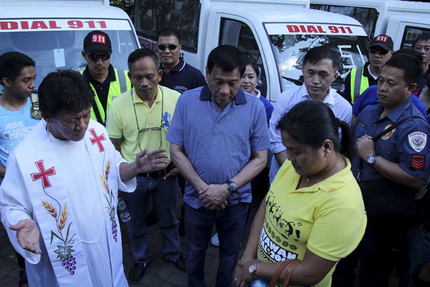 Fr. Bong Gonzaga, of the Saint Francis of Assisi Parish leads the prayer for the turnover ceremony of 86 motorcycles and 54 multicabs to every barangays in Davao City. The event held at the People's Park was graced by presidential aspirant and Davao City Mayor, Rodrigo Duterte. (Ace R. Morandante/davaotoday.com)