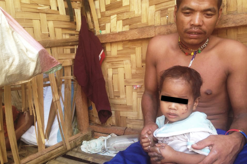 MANOBO FATHER AND SON. Loloy Manayab, a Manobo from Talaingod, Davao del Norte holds his 2-year-old son, Demon after they survived the fire inside the UCCP Haran compound on Wednesday, February 24. (Zea Io Ming C. Capistrano/davaotoday.com)